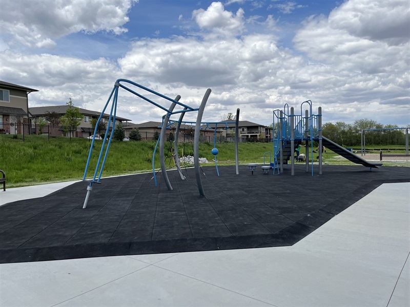 The playground at Prairie Village park featuring a climbing area and play structure 