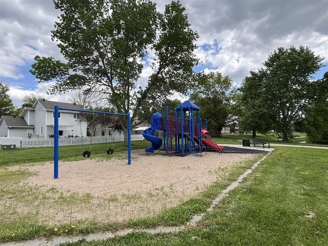 Playground featuring a swingset and playstructure.