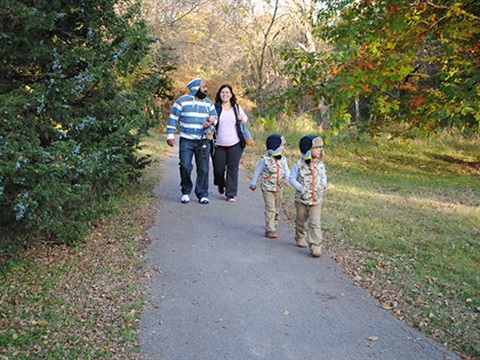 Photograph of family walking on park trail