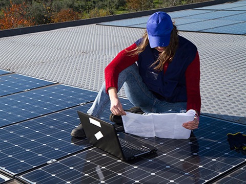 Photograph of solar panels being inspected